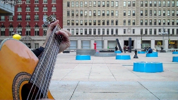 Daniel Brouse writing the Christmas song while surrounding by giant game pieces